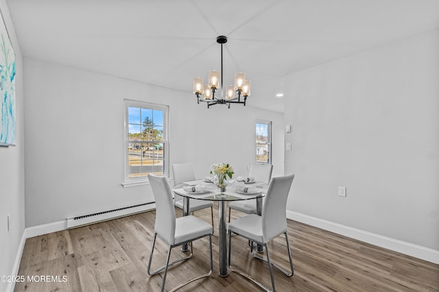 dining space featuring light wood-type flooring, baseboards, plenty of natural light, and baseboard heating