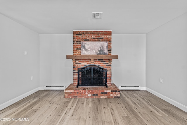 unfurnished living room with a fireplace, wood finished floors, visible vents, baseboards, and baseboard heating