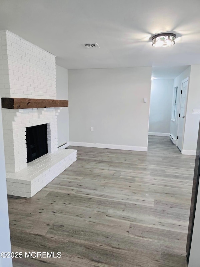 47 N Buckingham Dr, Manchester, NJ 08759 - unfurnished living room with baseboards, wood finished floors, and a fireplace