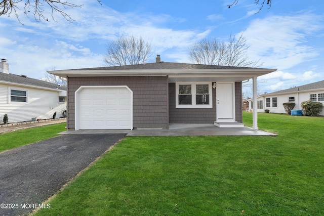 single story home featuring a garage and a front yard