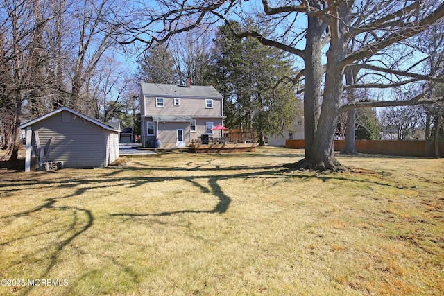 view of yard with fence and a wooden deck