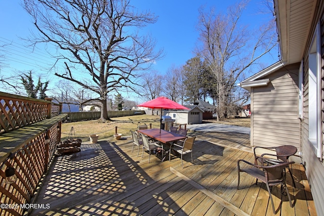 deck with outdoor dining space and an outdoor structure