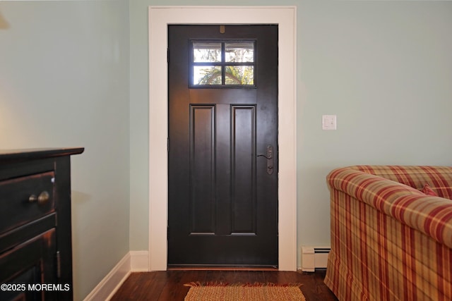 foyer entrance featuring a baseboard radiator, wood finished floors, and baseboards