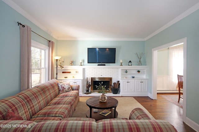 living room featuring baseboards, dark wood finished floors, ornamental molding, baseboard heating, and a fireplace