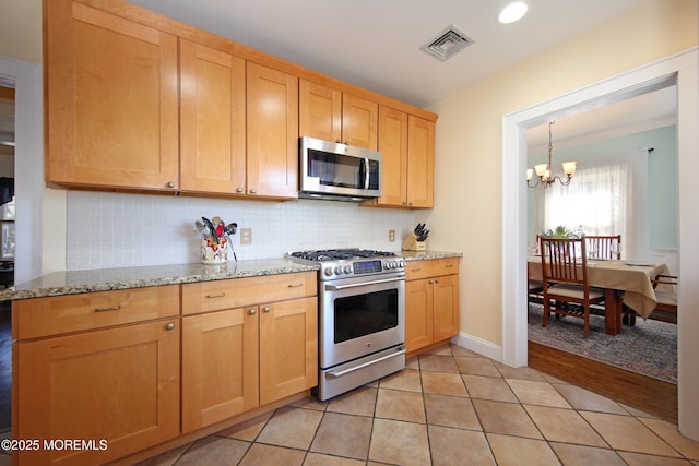 kitchen featuring light tile patterned floors, visible vents, appliances with stainless steel finishes, backsplash, and an inviting chandelier