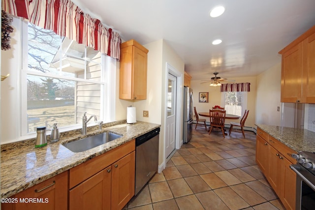 kitchen featuring a baseboard radiator, recessed lighting, appliances with stainless steel finishes, a ceiling fan, and a sink