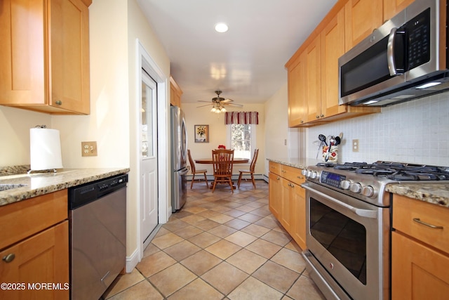 kitchen featuring a ceiling fan, stainless steel appliances, decorative backsplash, and light brown cabinetry