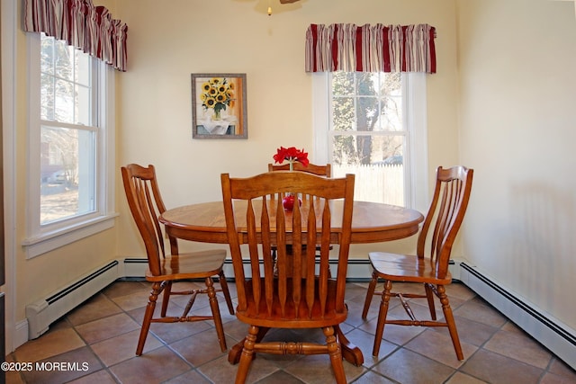 tiled dining space with a baseboard radiator