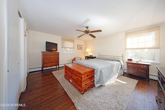 bedroom with baseboard heating, a baseboard radiator, dark wood finished floors, and a ceiling fan