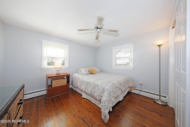 bedroom featuring a ceiling fan, baseboard heating, and wood finished floors