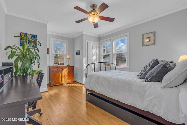 bedroom featuring ceiling fan, ornamental molding, light wood-style flooring, and baseboards