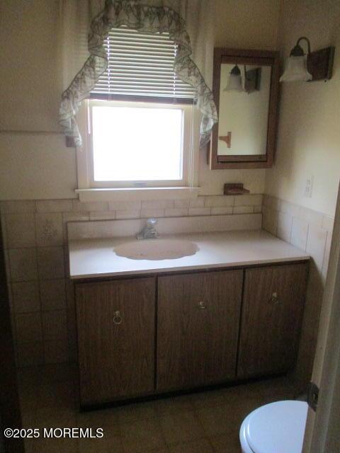 bathroom featuring toilet and vanity