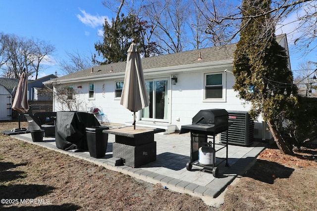 rear view of property featuring central AC unit and a patio