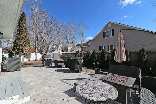 view of patio / terrace with a grill and an outdoor fire pit