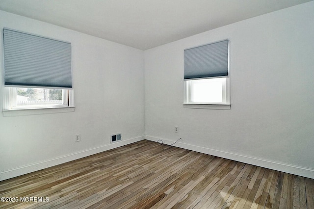 spare room featuring wood-type flooring