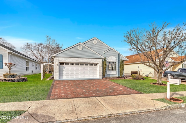 view of front of home with a garage and a front lawn