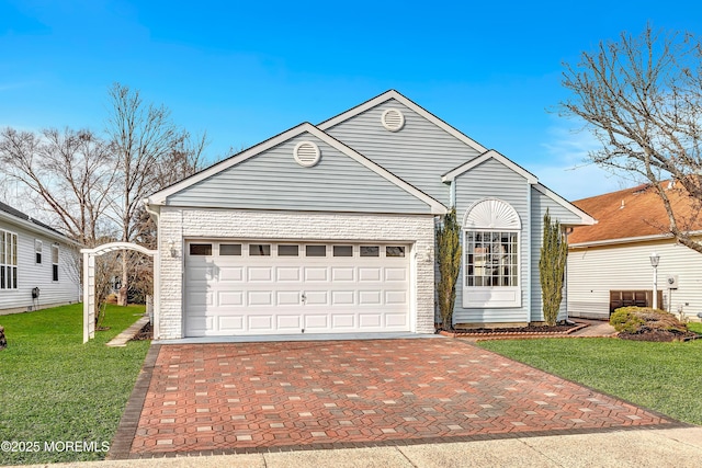 view of property featuring a garage and a front yard