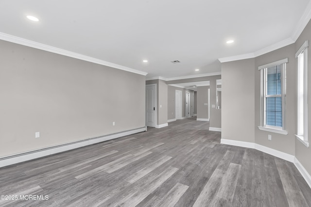 empty room with crown molding, baseboard heating, and light hardwood / wood-style floors