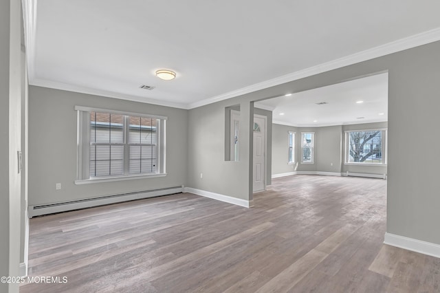 empty room with a baseboard radiator, ornamental molding, and light hardwood / wood-style floors