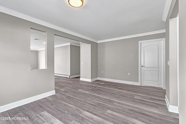 unfurnished room with a baseboard heating unit, crown molding, and light hardwood / wood-style floors