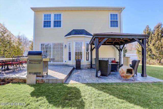 back of property with an outdoor living space, a gazebo, a lawn, and a patio area