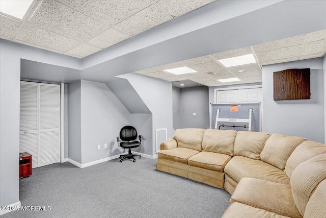 carpeted living room with a drop ceiling