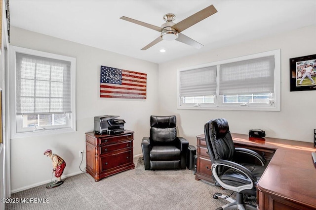 carpeted office space with ceiling fan