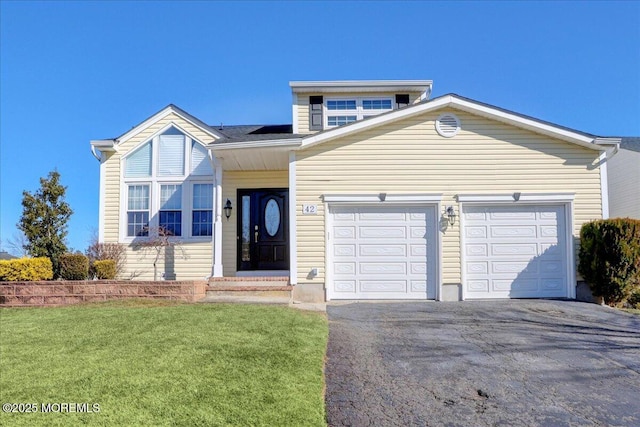 view of front of property with a garage and a front yard