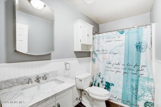 bathroom featuring vanity, toilet, and walk in shower