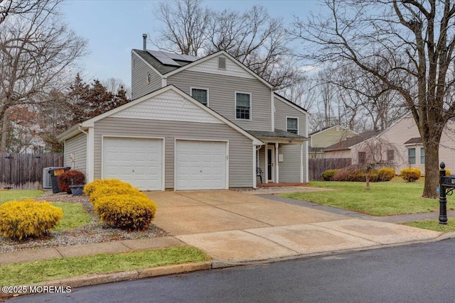 front of property featuring a front yard, central AC unit, and solar panels