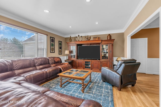 living room featuring ornamental molding, a wealth of natural light, and wood finished floors