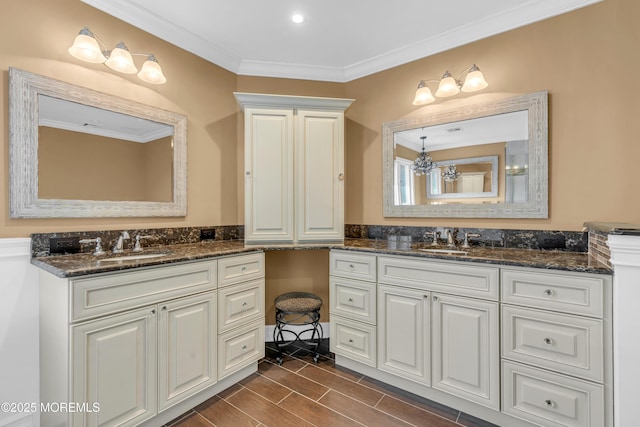 bathroom featuring crown molding, wood tiled floor, two vanities, and a sink