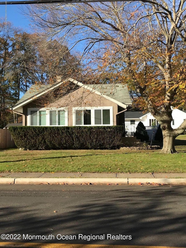 view of side of home featuring a yard