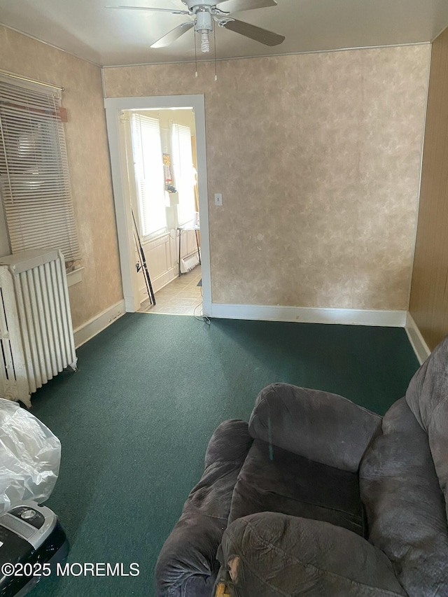 living room with ceiling fan, carpet flooring, and radiator