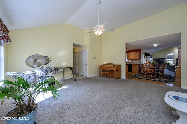 living area featuring high vaulted ceiling, ceiling fan, and light colored carpet