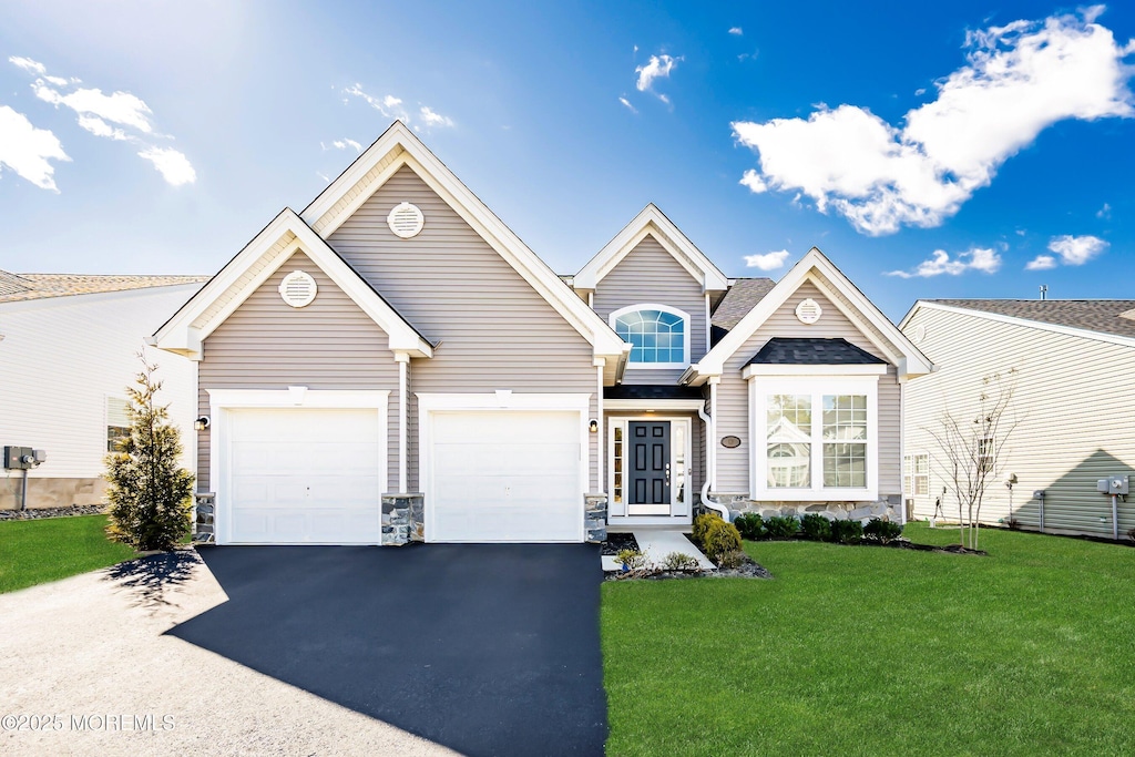 front facade featuring a front yard and a garage