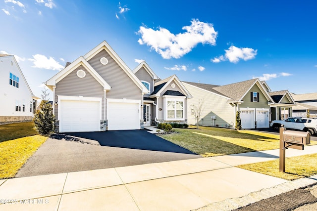 view of front of home with a front yard and a garage