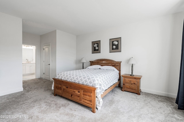 bedroom with light carpet and ensuite bath