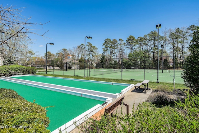 view of community featuring tennis court