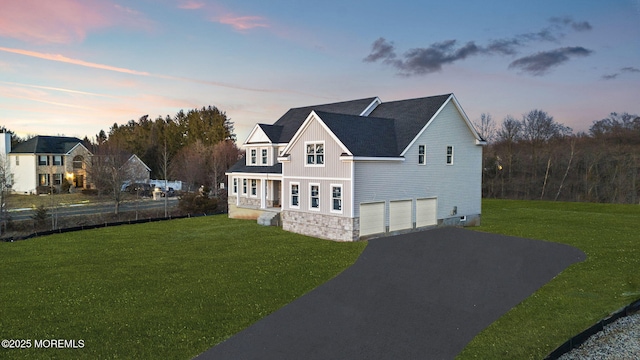 view of front facade featuring a garage and a lawn