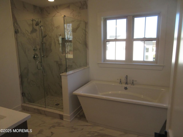 bathroom featuring vanity and shower with separate bathtub