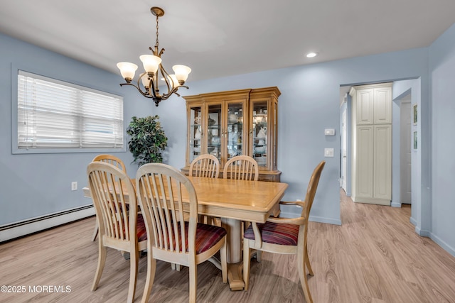 dining room with a chandelier, recessed lighting, light wood-style flooring, and baseboards