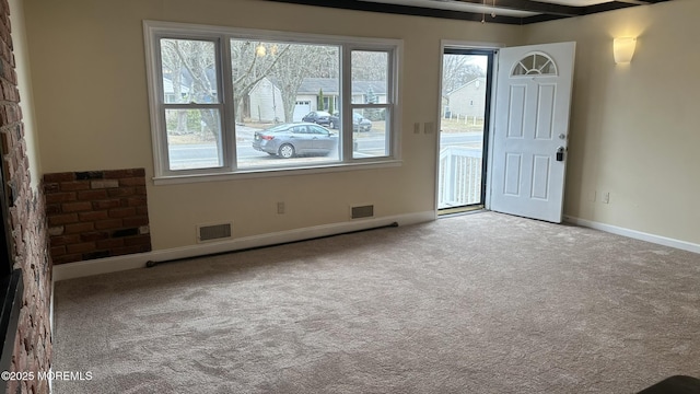 unfurnished room with baseboards, visible vents, and carpet floors