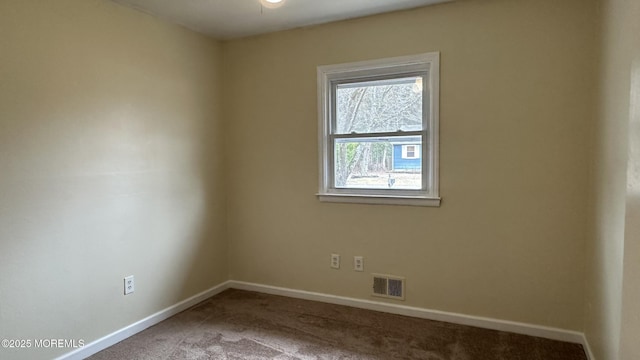 carpeted empty room with visible vents and baseboards