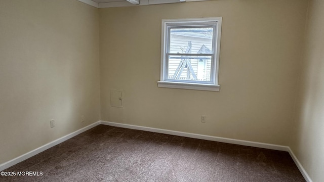 spare room featuring baseboards and carpet flooring