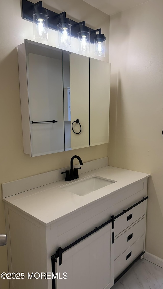 bathroom with marble finish floor and vanity