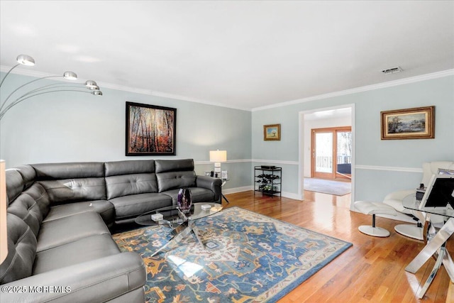 living room with ornamental molding and hardwood / wood-style flooring