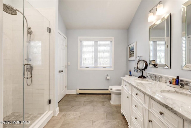 bathroom with vanity, an enclosed shower, a baseboard radiator, and a wealth of natural light