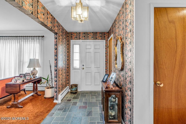 foyer entrance featuring a baseboard heating unit