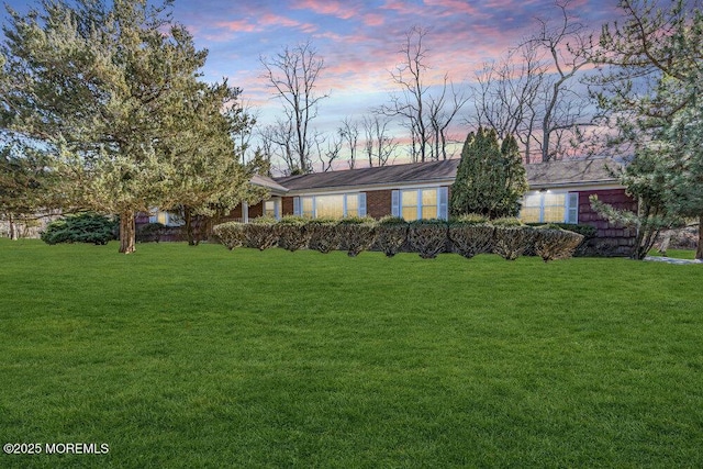 ranch-style house with a yard